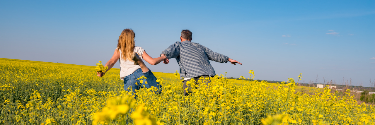 6 Things Life With an Ostomy Isn't Romantic couple running through a field.
