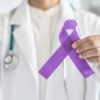 doctor holding purple epilepsy awareness ribbon