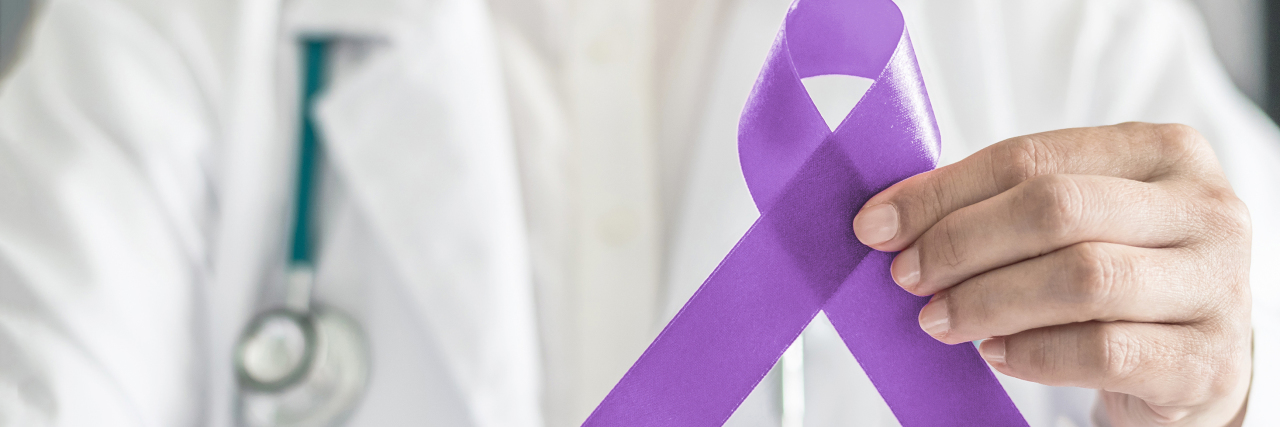 doctor holding purple epilepsy awareness ribbon