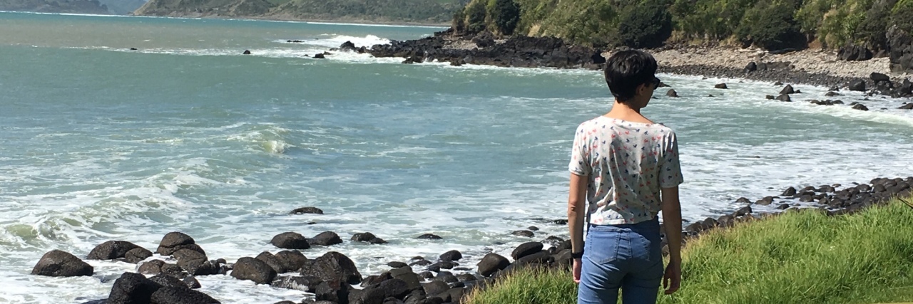 Why You Shouldn't Compliment Someone's Weight Loss the author walking along a grassy shoreline by the beach