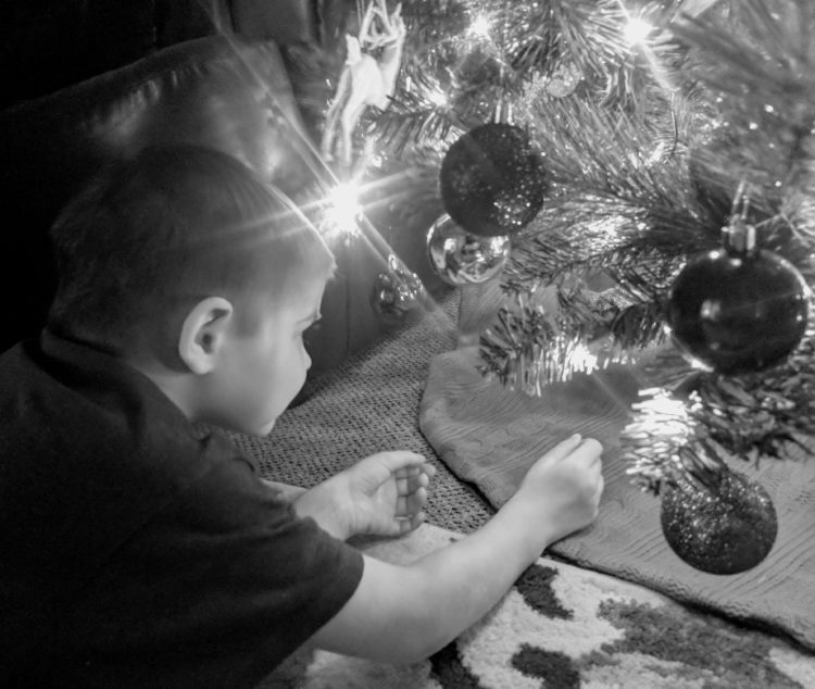 The author's child by the christmas tree