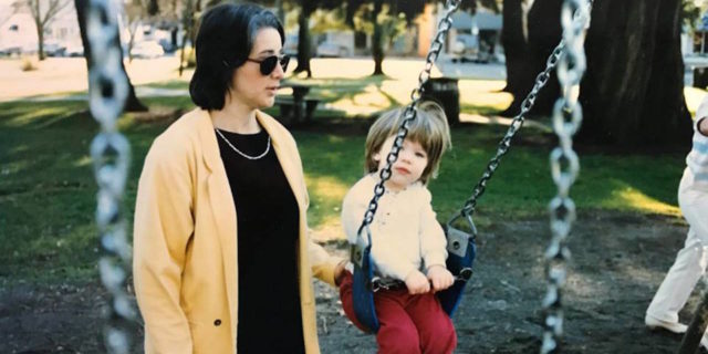 The author as a child and her mother, pushing her on a swing set