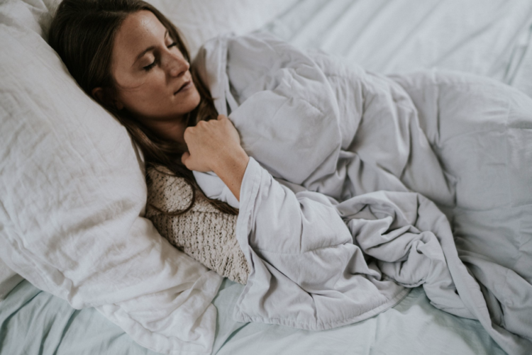 Woman sleeping under weighted blanket