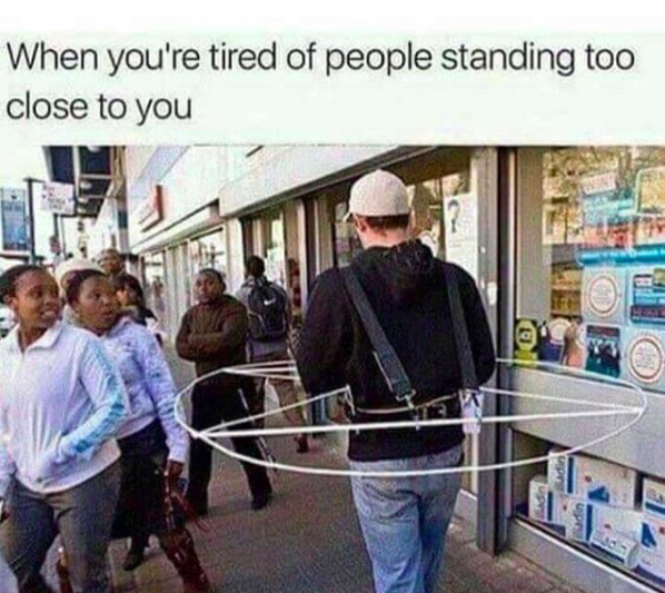 when you're tired of people standing close to you: man wearing hula hoop around him