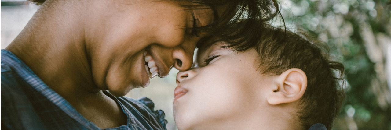 A mom looking adoringly at her son. Text reads: The 18 Hardest Parts of Being an Anxious Mama