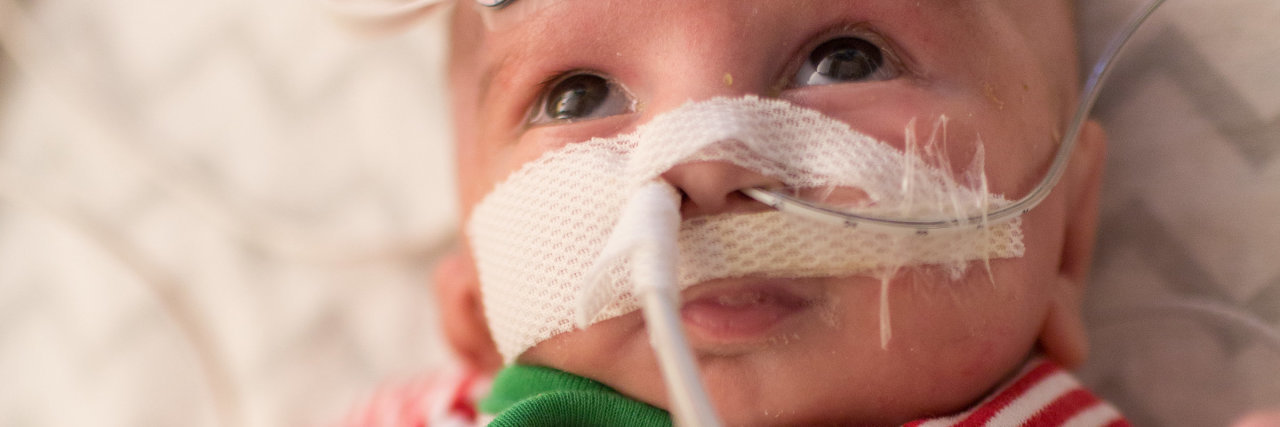 The Christmas Letter My Son Will Never Get to Read a baby boy with a Christmas themed outfit in the hospital