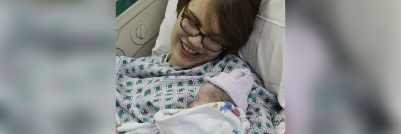 My Pregnancy With Undiagnosed Chronic Illnesses the author lying in a hospital bed holding her newborn baby