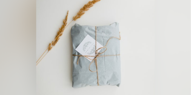 package wrapped in blue paper with brown string