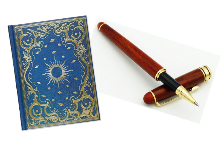 Blue and gold celestial-patterned journal and wooden writing pen