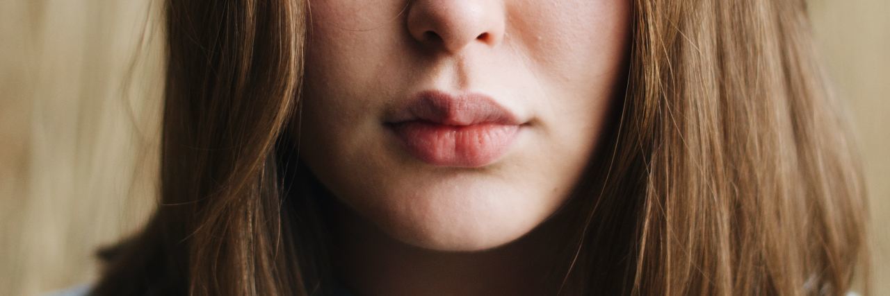 photo of woman close up looking into camera with serious expression