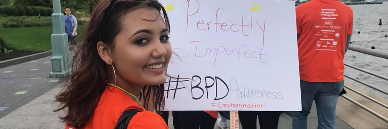 young latina woman looking at camera and smiling during walk for borderline personality disorder