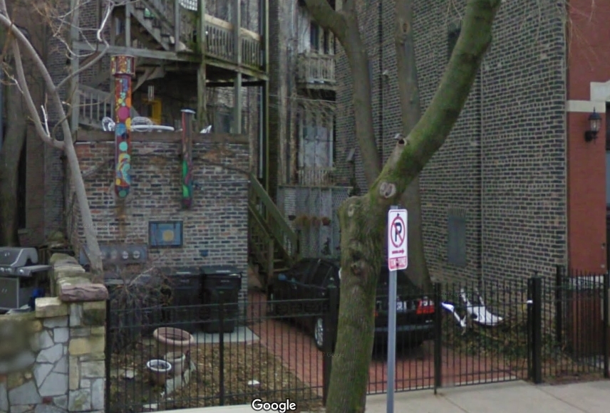 The Chicago house in 2009, looking run down with graffiti and trash in the back.