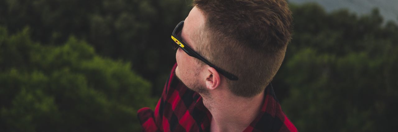 Why Men Don’t Sign Up for Dialectical Behavior Therapy man with glasses looking out over trees and water