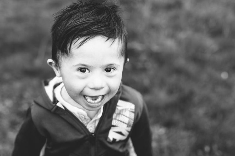 a little boy with Down syndrome smiling