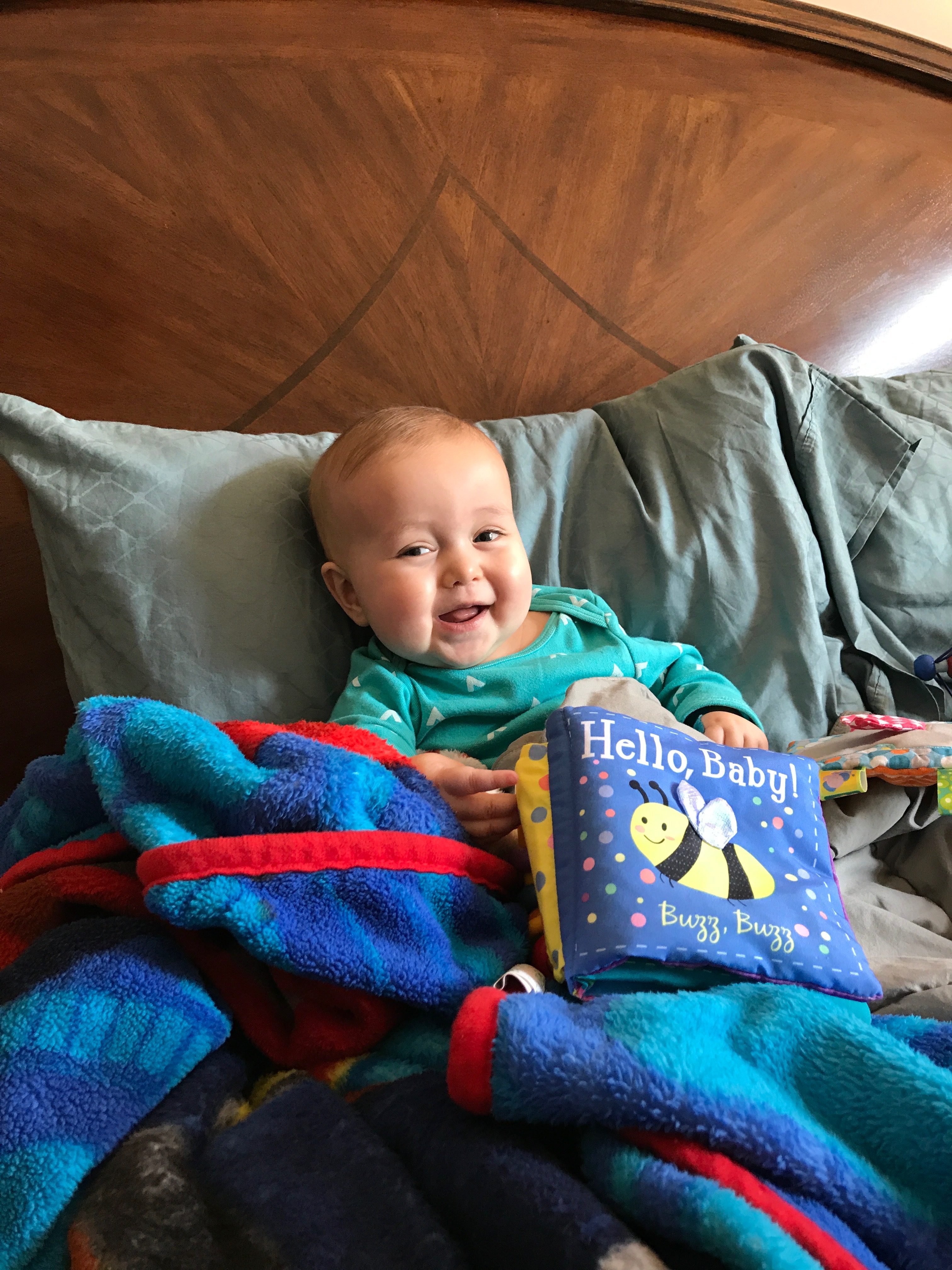 Owen laying on a pillow, smiling.