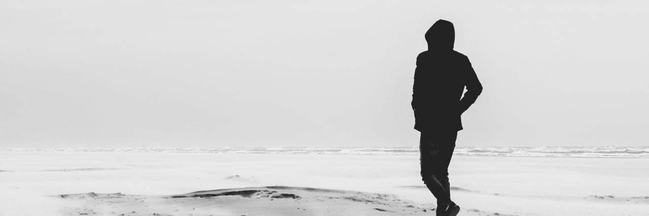 11 Things to Do When You Feel Like You Don't Have Anybody A person dressed in black is walking alone on a pale-grey beach. 11 Things to Do When You Feel Like You Don't Have Anybody