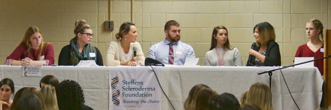 How to Create a Comprehensive Care Team for Your Health author sitting on a panel onstage