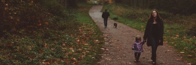 Image of a mother and child walking down a path in the park
