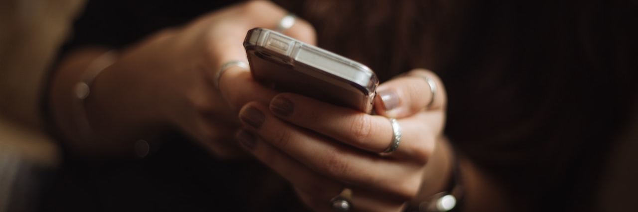 Crisis Text Line Launches In Canada Providing Mental Health Services Feminine-looking hands holding cell phone and presumably texting