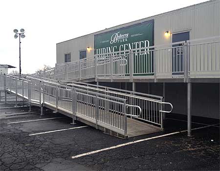 Long metal switchback ramp to enter a building.