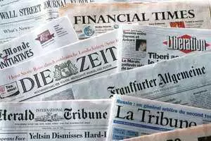 Pile of newspapers from various countries.