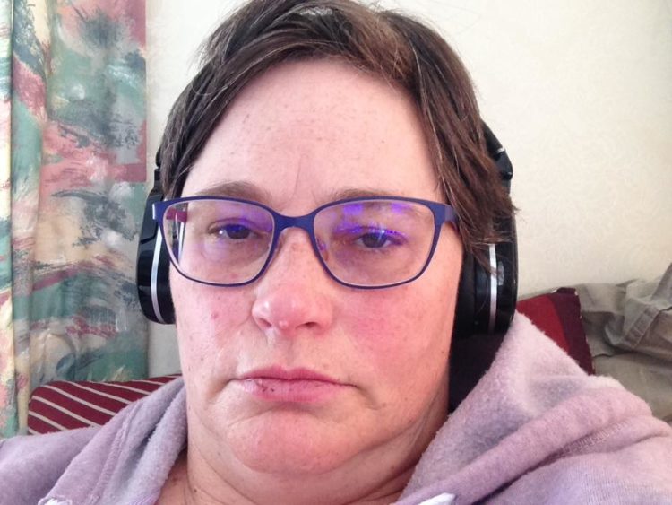 selfie of woman wearing glasses and headphones with flushed cheeks