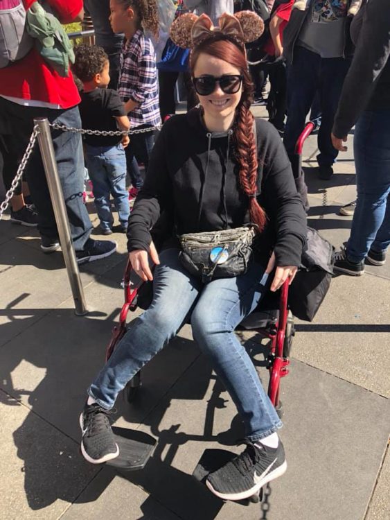 woman sitting in wheelchair at disneyland