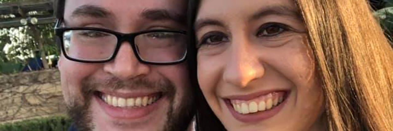 A Love Letter to My Girlfriend Who Has Cerebral Palsy Louis and Kelly standing outside, smiling.