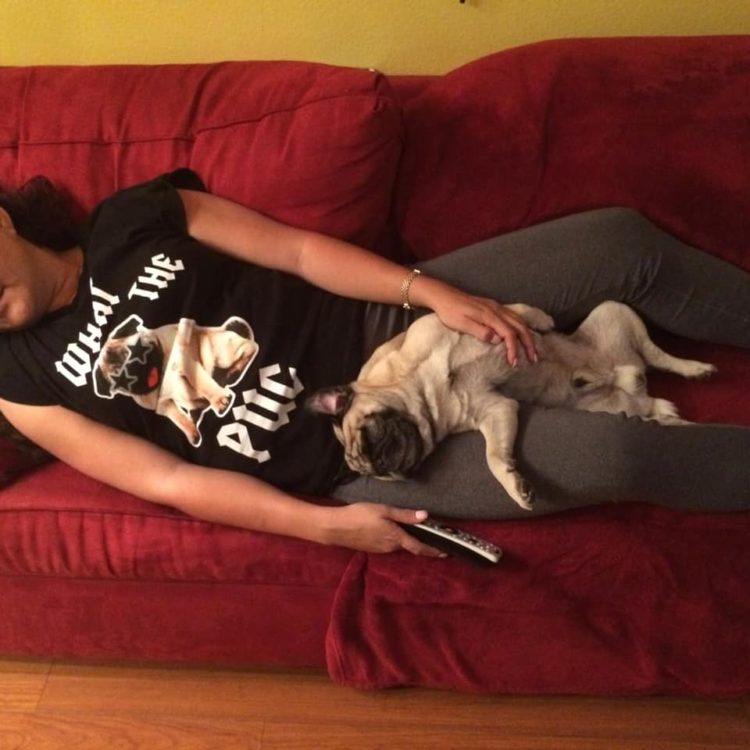 woman laying with a pug