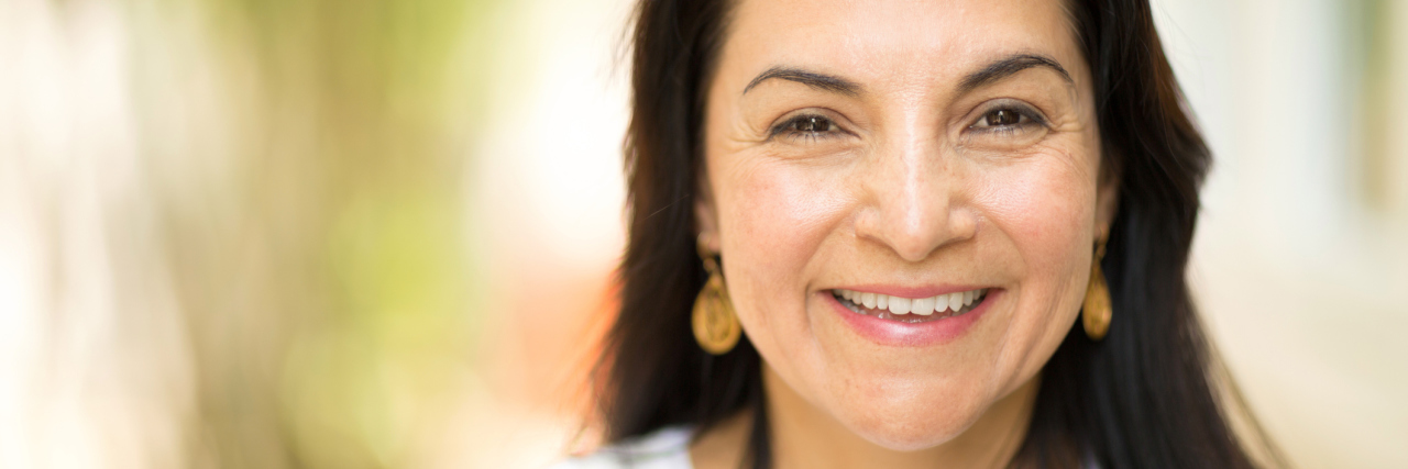Learning Self-Care With Fibromyalgia portrait of a woman with long dark hair smiling