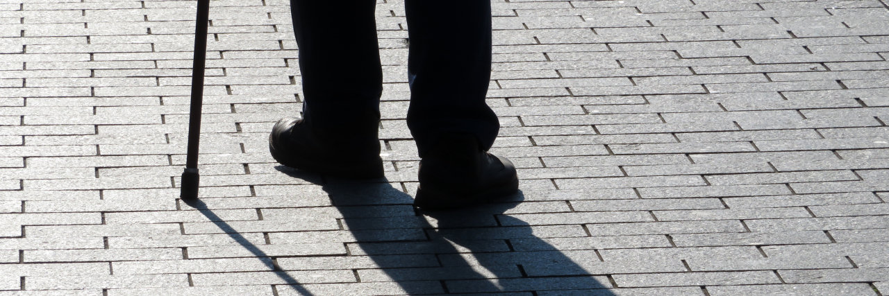 How Ableism Contributes to Poverty Silhouette of man walking with a cane.