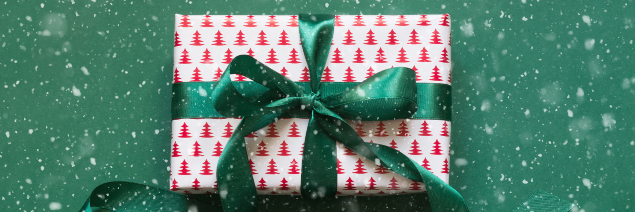 Christmas gift box with green ribbon.