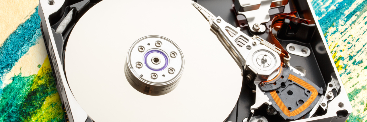 How Autistic Shutdown Is Like Disk Defragmentation Hard drive sitting on colorful table.