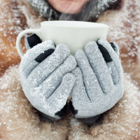 woman holding a mug outside in the snow