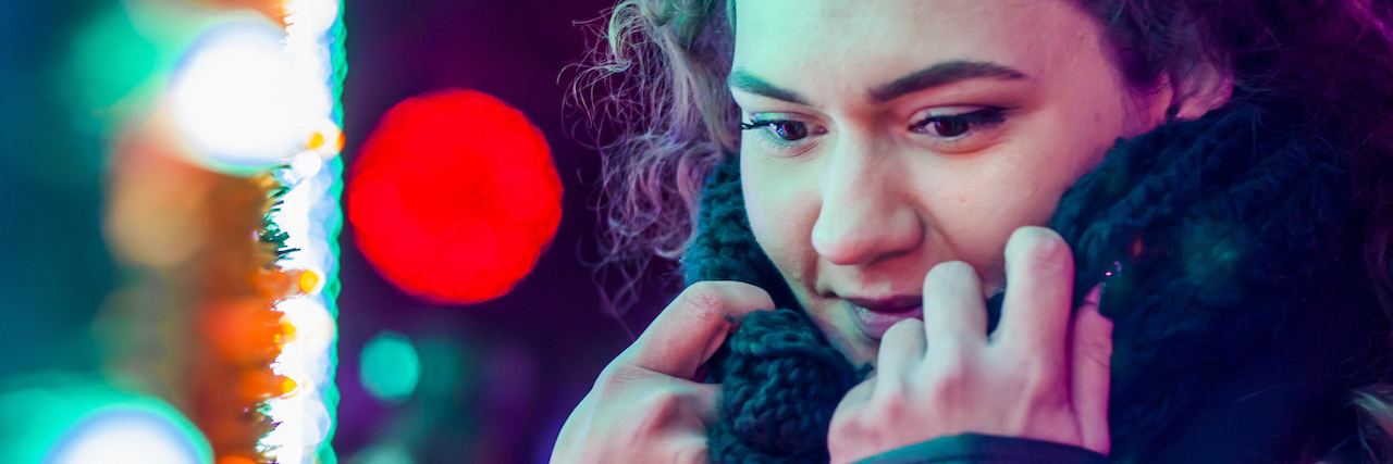 Tips for Christmas Dinner When You're in Eating Disorder Recovery A woman outside in the cold with a scarf