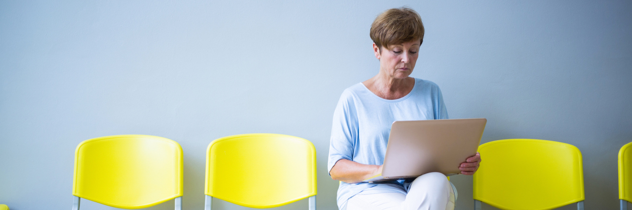 How to Cope With Stress and Anxiety of Doctor Appointments female patient sitting in a waiting room reading a report