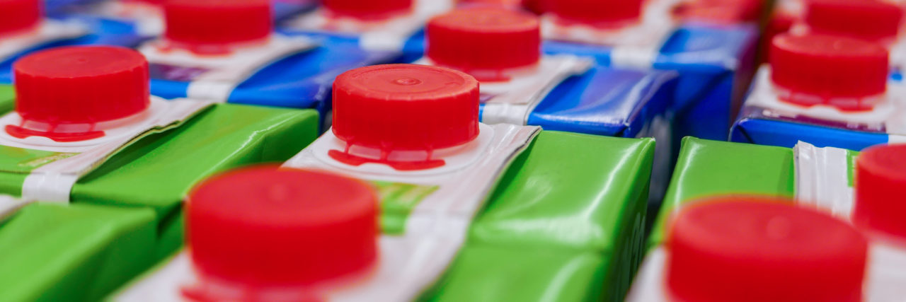 Please Stop Doubting That I'm Autistic Cartons on supermarket shelf.