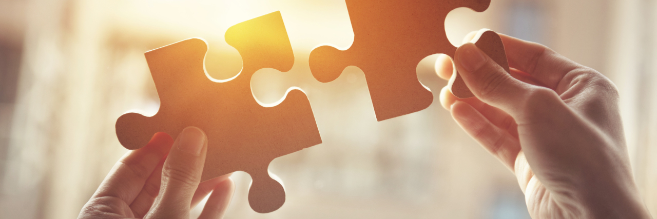 Seeking an Autism Diagnosis as an Adult Woman Woman putting two puzzle pieces together.