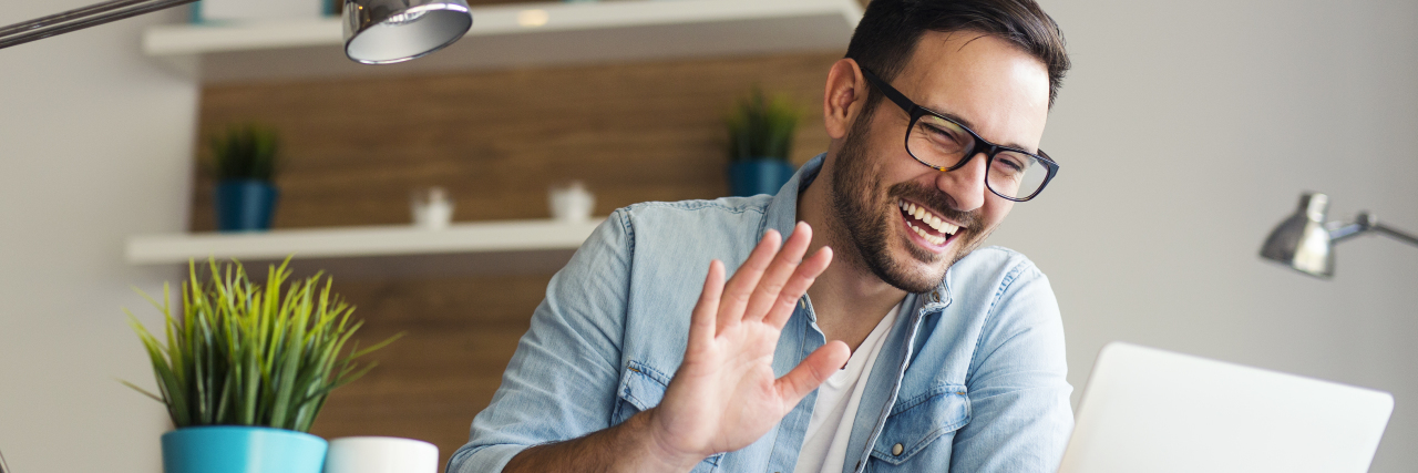 Introducing Myself as a Person Who Stutters A man smiling and waving on a computer video chat