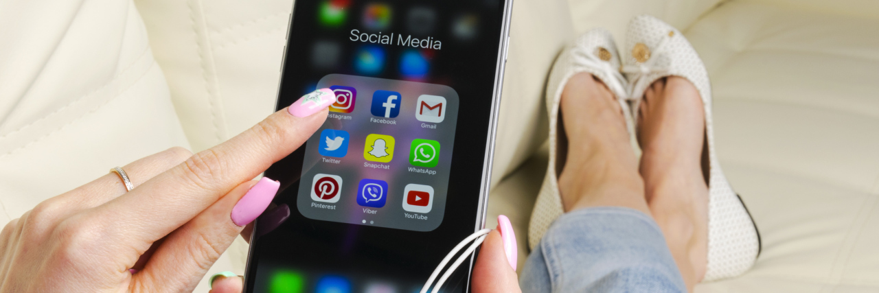 It's OK If You Don't Want to Share All Your Experiences With Illness woman holding her phone and opening instagram