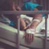Woman lying in bed in hospital.