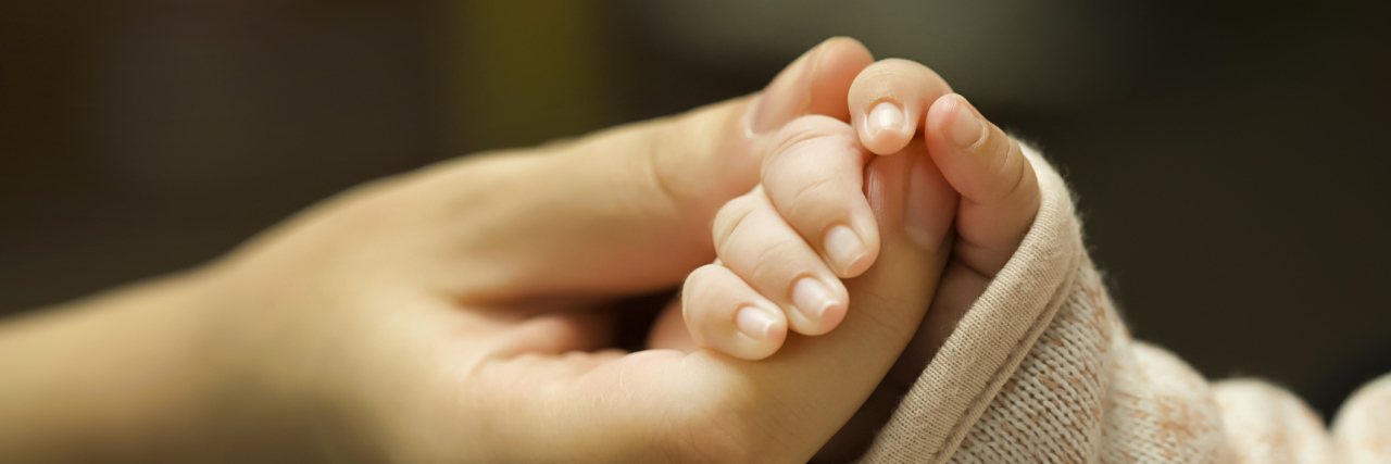 To the Moms of Kids With Disabilities, Your Voice Matters Close up of child holding on to mother's hand