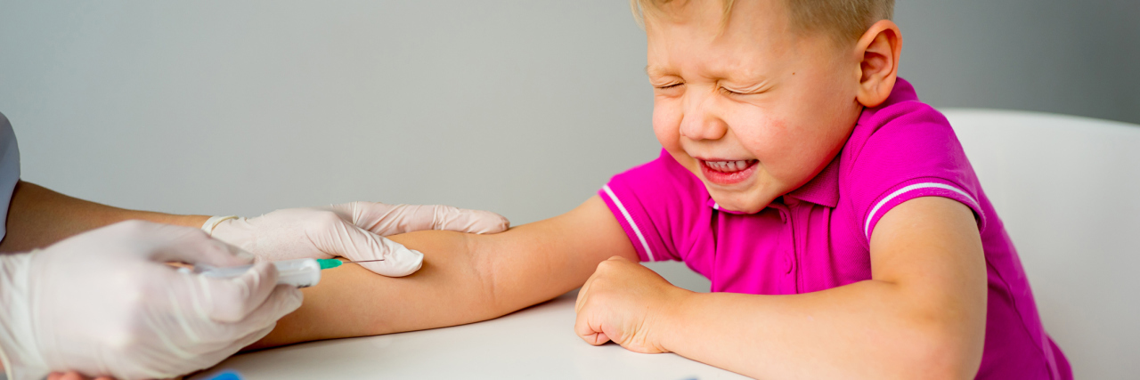 How I Help My Child Cope With Needle Anxiety Little boy flinching as he is about to have blood drawn