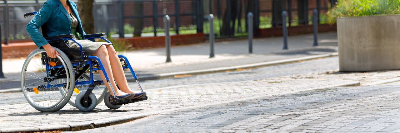 My Love/Hate Relationship With My Wheelchair Woman in wheelchair crossing the street.