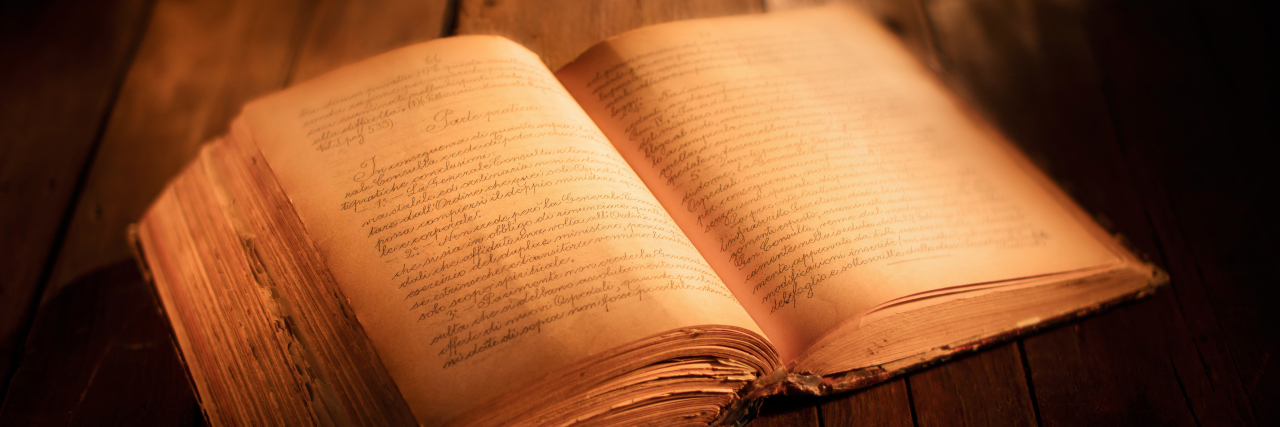 Writing About Characters With Autism in Historical Fiction Old book on a wooden table.