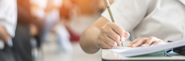 Student taking an exam with a blurred background.