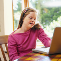 Teenage girl with Down syndrome on her laptop