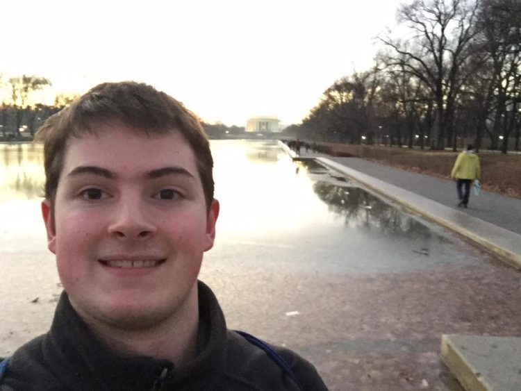 man in front of lake selfie