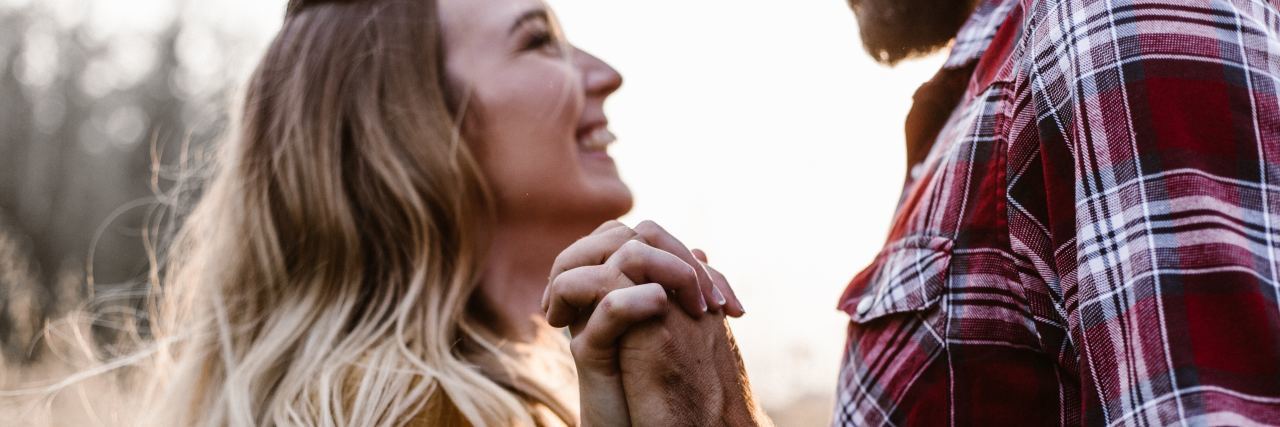 How to Maintain a Healthy Relationship When You Have a Chronic Illness man and woman holding hands and facing each other, smiling