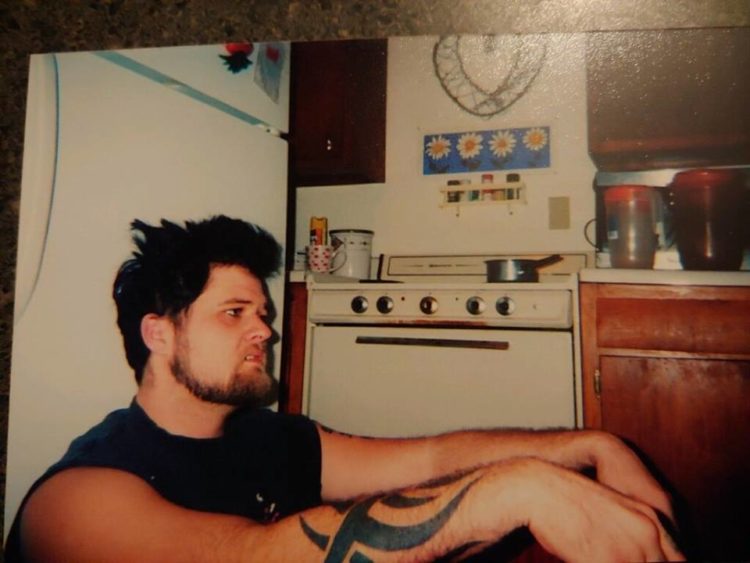 man sitting in kitchen on floor